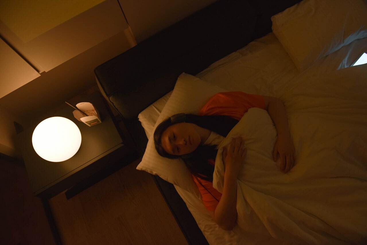 woman lying in bed awake